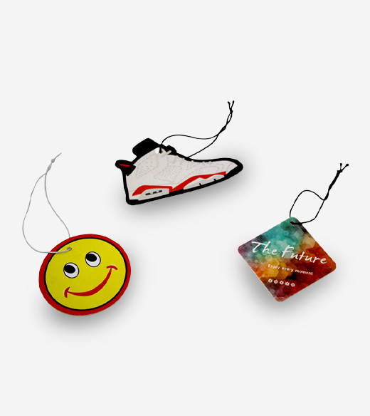 Three hanging paper air fresheners with different custom shapes and designs